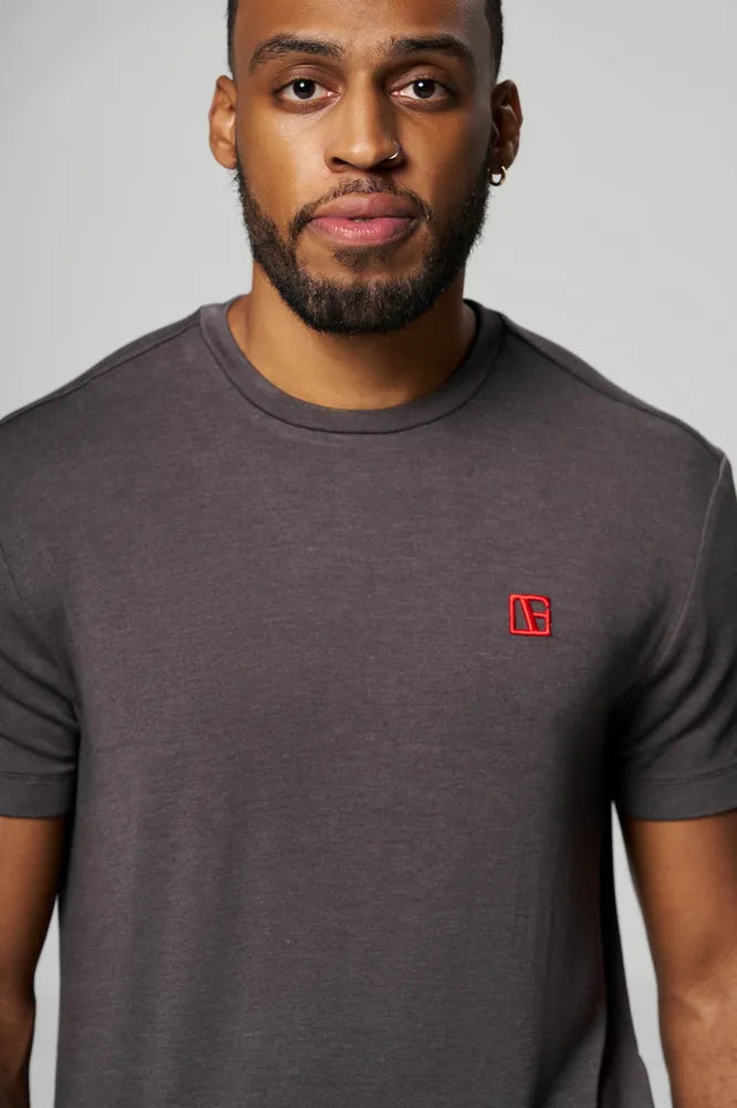 a man is wearing gray t shirt with red etn logo