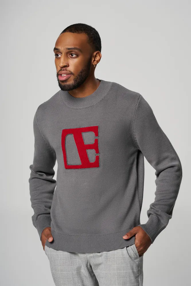 a man is wearing Gray-Red Label Sweater looking in a side pose