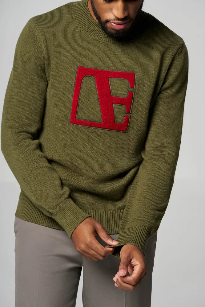 a man is wearing Forest Green-Red Label Sweater folding his sleeves