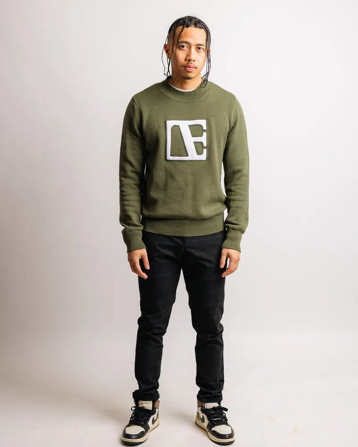 a man is wearing Forest Green-Executive Label Sweater standing