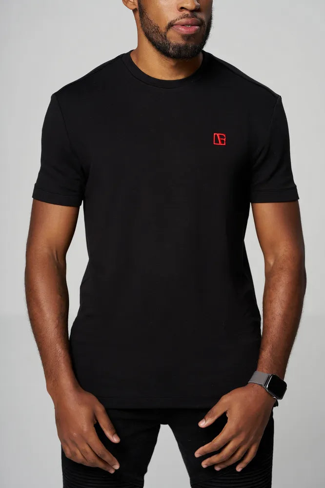 a man is wearing black t shirt with red etn logo