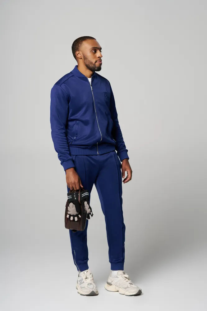 a man is wearing Blue Tracksuit