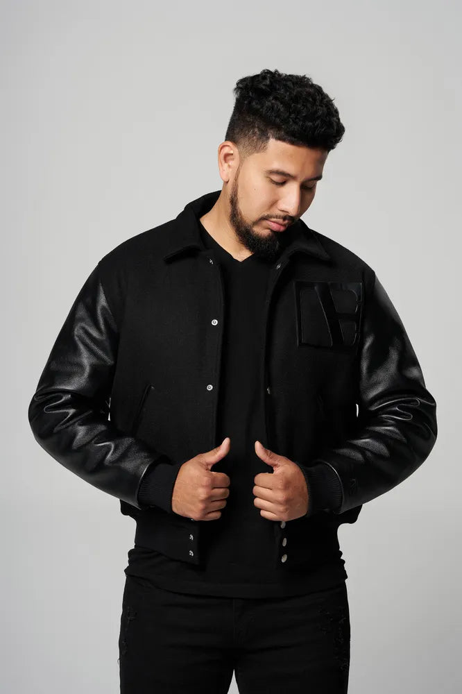 a man is wearing Black-Executive Label Letterman