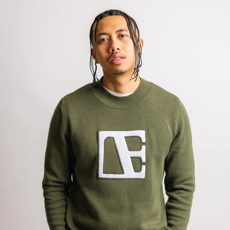 a man is wearing Forest Green-Executive Label Sweater