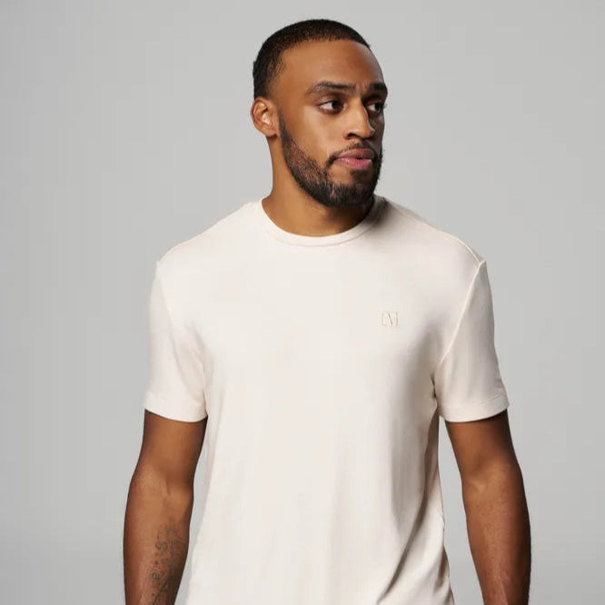 a man is wearing a shirt in cream color