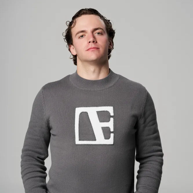 a man wearing Gray-Executive Label Sweater standing