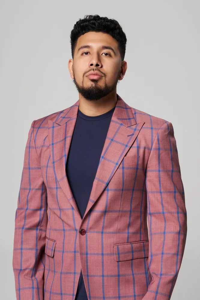 a man is wearing a pink coat with blue t-shirt