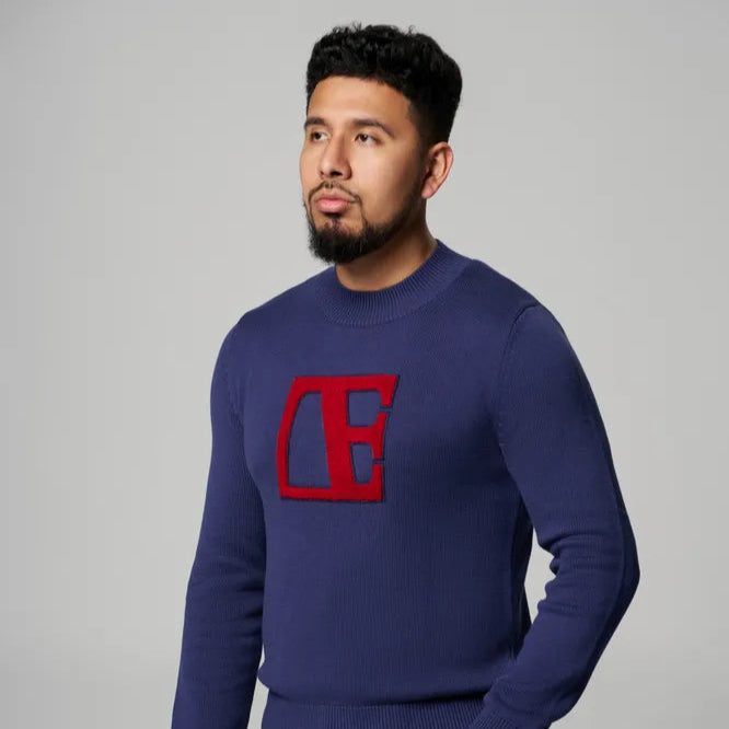 a man is wearing  Blue-Red Label Sweater standing