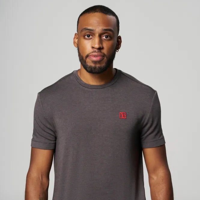 a man is wearing Gray-Red Label T-Shirt standing
