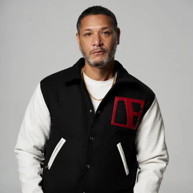 a man is wearing a letterman jacket