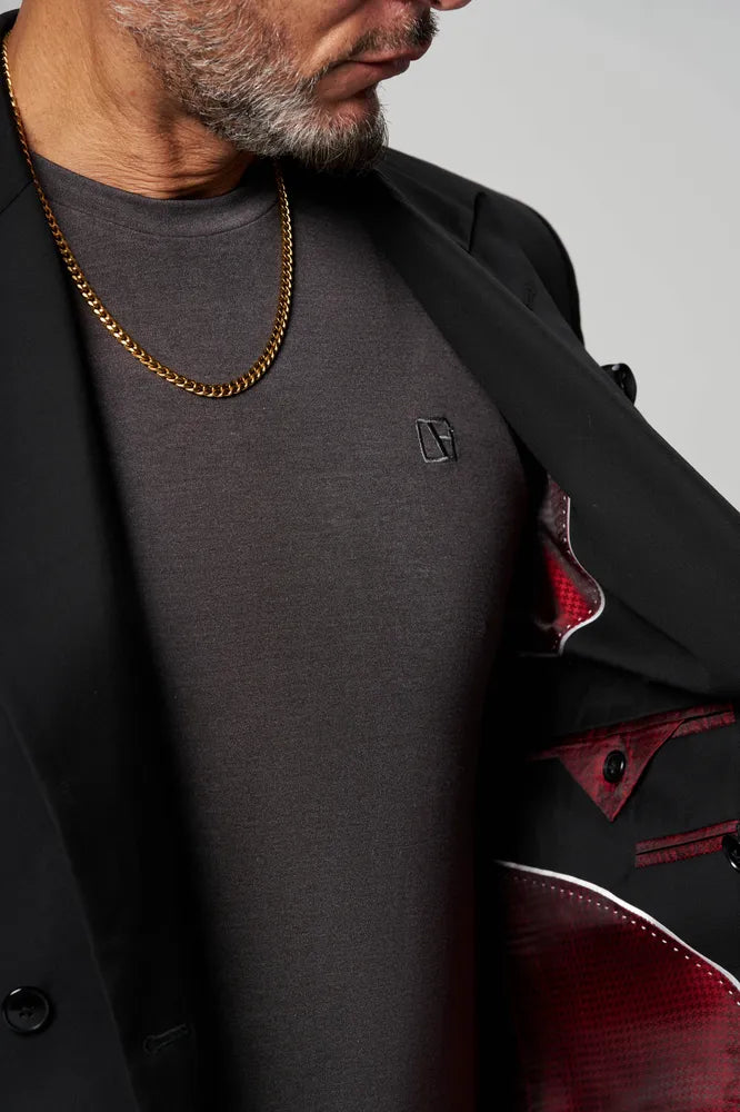 a man is wearing grey t shirt with black coat