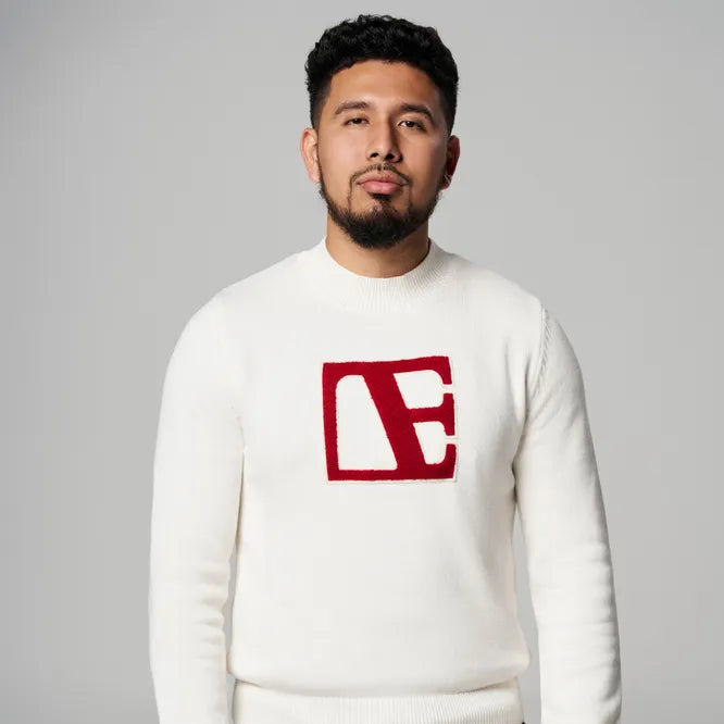 a man is wearing Cream -Red Label Sweater standing