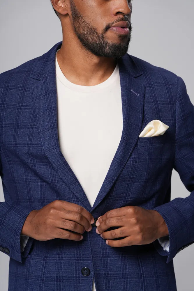 a man wearing Cream-Executive Label T-Shirt with blue coat