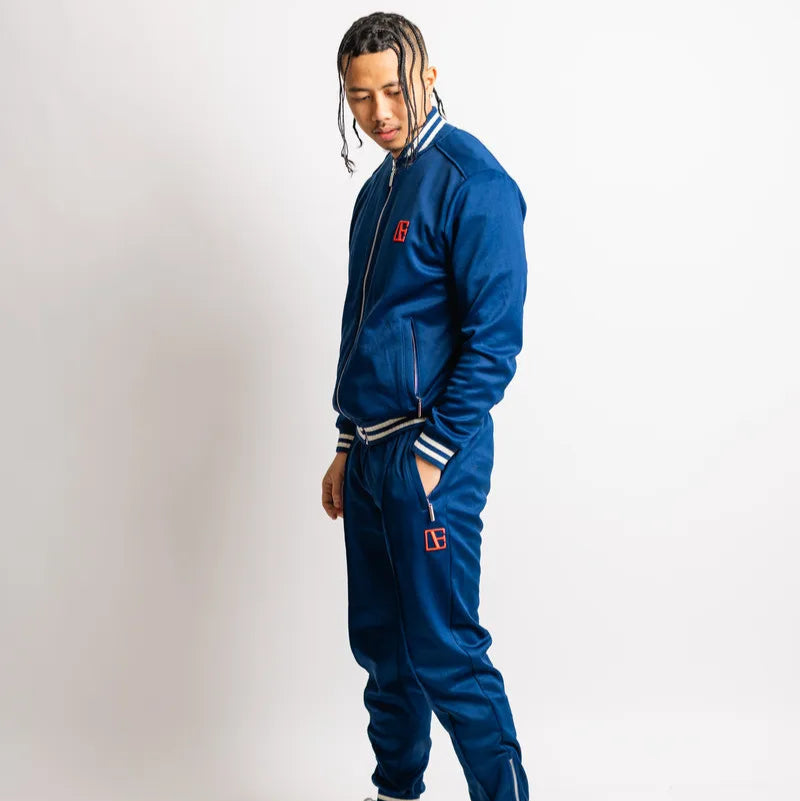a boy is standing wearing Blue-Red Label Tracksuit
